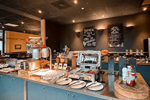 Restaurant of Amrâth Berghotel Amersfoort with a buffet and a long counter for guests.