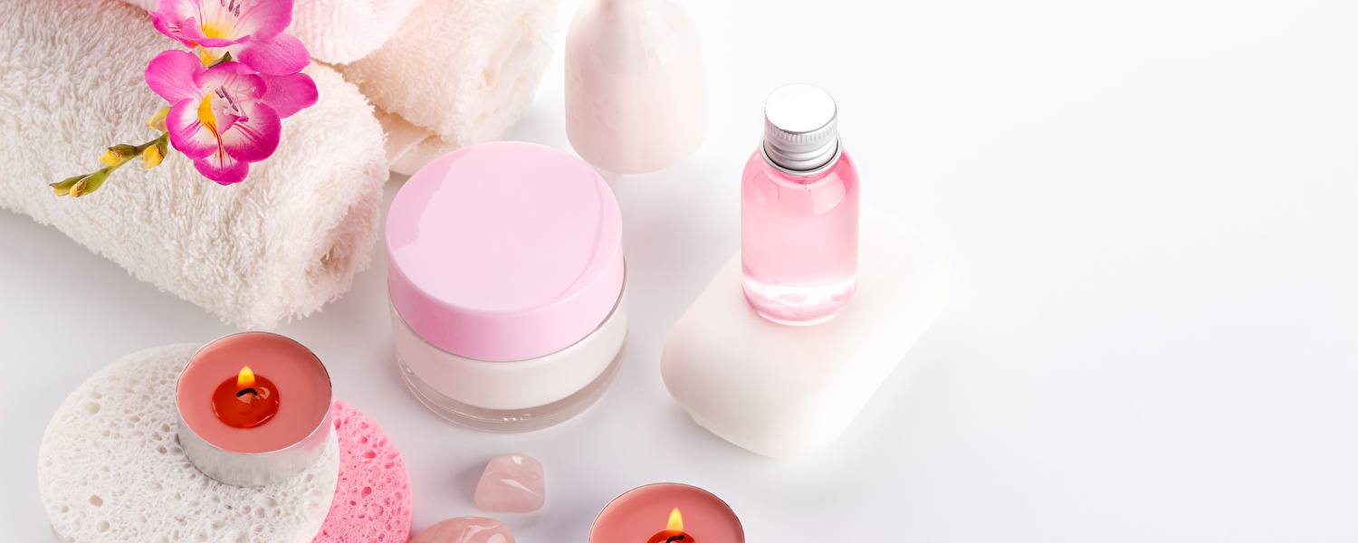Various spa products such as oils and soaps on a white background.